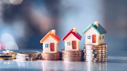 Model homes with stacks of coins underneath them indicate rising housing costs and limited housing affordability. Model homes with stacks of coins underneath them indicate rising housing costs and limited housing affordability.