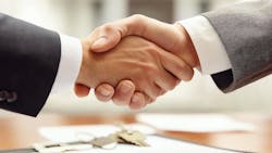 Two businessmen shaking hands on a deal represents the acquisition of Azek by James Hardie. Two businessmen shaking hands on a deal represents the acquisition of Azek by James Hardie.