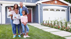 A black family stands in front of a house, representing minority homeownership.
