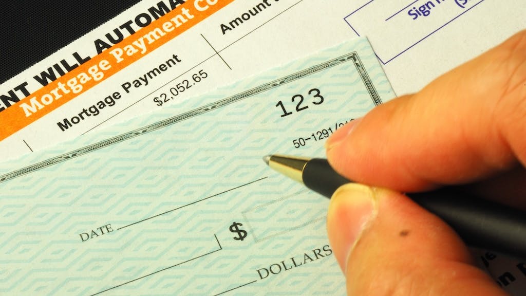 Homeowner writing a check for a mortgage payment