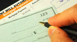 Homeowner writing a check for a mortgage payment
