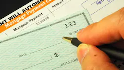 Homeowner writing a check for a mortgage payment