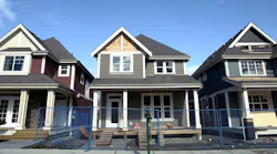 A row of new single-family homes nearing completion as new-home inventory reaches new highs.