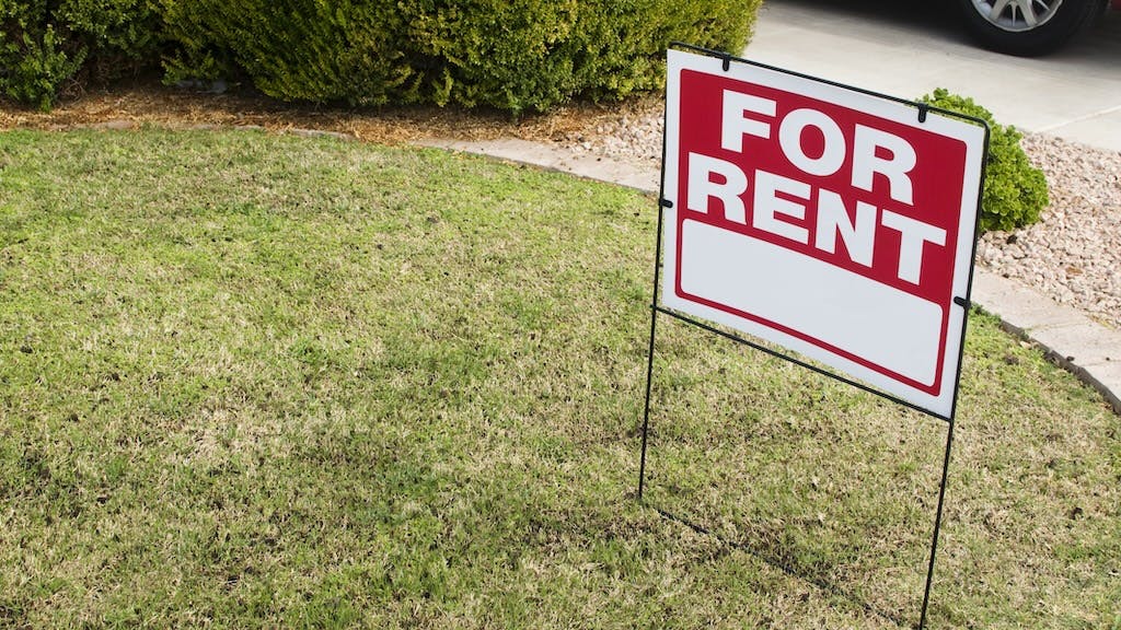 A 'For Rent' sign in a front yard as rent prices increase slightly.