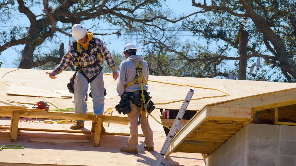 Construction workers working on a roof