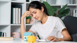 A homeowner looks stressed out as they go over their monthly housing costs A homeowner looks stressed out as they go over their monthly housing costs