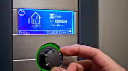 A homeowner changes the temperature on their thermostat