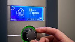 A homeowner changes the temperature on their thermostat A homeowner changes the temperature on their thermostat