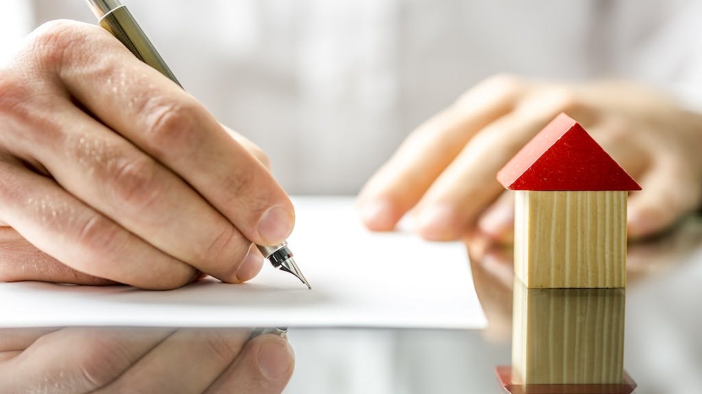 A homebuyer signs for a home