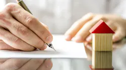 A homebuyer signs for a home