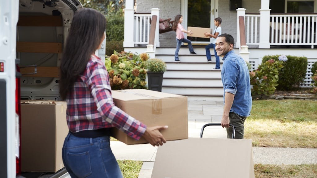 A Hispanic family moves into a new home, but home values in Hispanic neighborhoods aren't keeping pace with communities dominated by other demographic types.