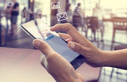 Person using smartphone to send new-home sales follow-up emails. Person using smartphone to send new-home sales follow-up emails.