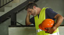 A stressed construction worker represents the challenges the construction industry faces regarding mental health.