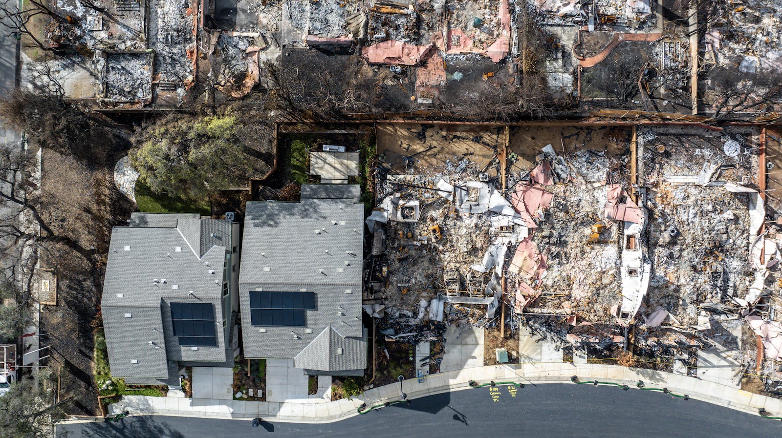 Two homes remain standing after the 2025 Eaton Fire in Altadena, Calif.