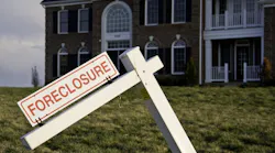 A suburban home with a foreclosure sign in the front yard