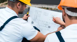 Home builders working together to figure out a home's floor plan so it is less expensive to build.