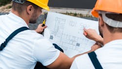 Home builders working together to figure out a home's floor plan so it is less expensive to build. Home builders working together to figure out a home's floor plan so it is less expensive to build.