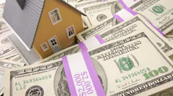 A model home sitting on stacks of money represents home equity