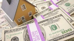A model home sitting on stacks of money represents home equity A model home sitting on stacks of money represents home equity