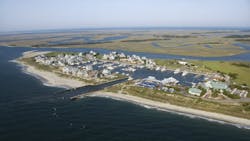Aerial view of coastal homes in North Carolina, a location prone to extreme weather events and sea-level rise. Aerial view of coastal homes in North Carolina, a location prone to extreme weather events and sea-level rise.