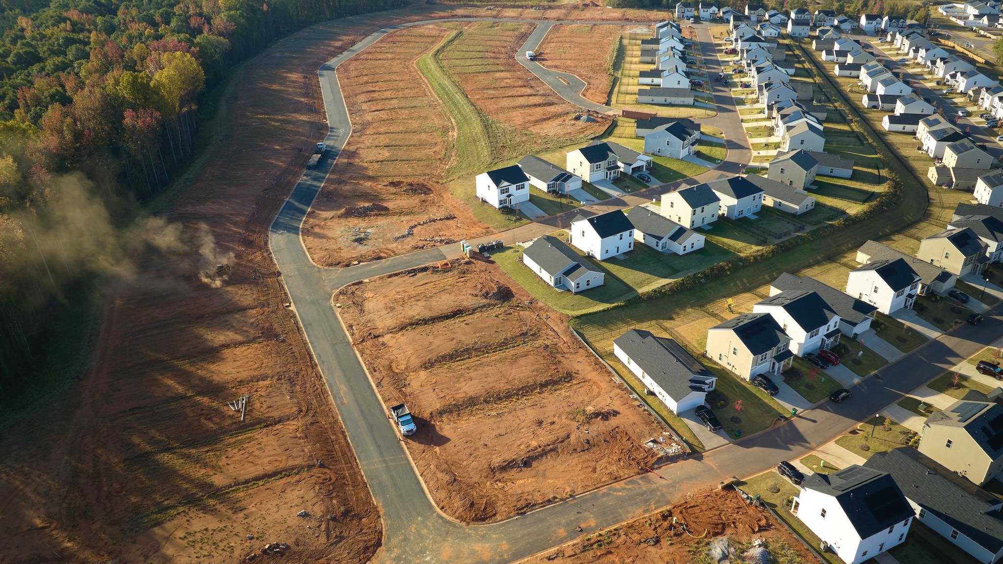 Housing development with cleared lots waiting for building indicate decrease in housing starts