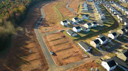 Housing development with cleared lots waiting for building indicate decrease in housing starts