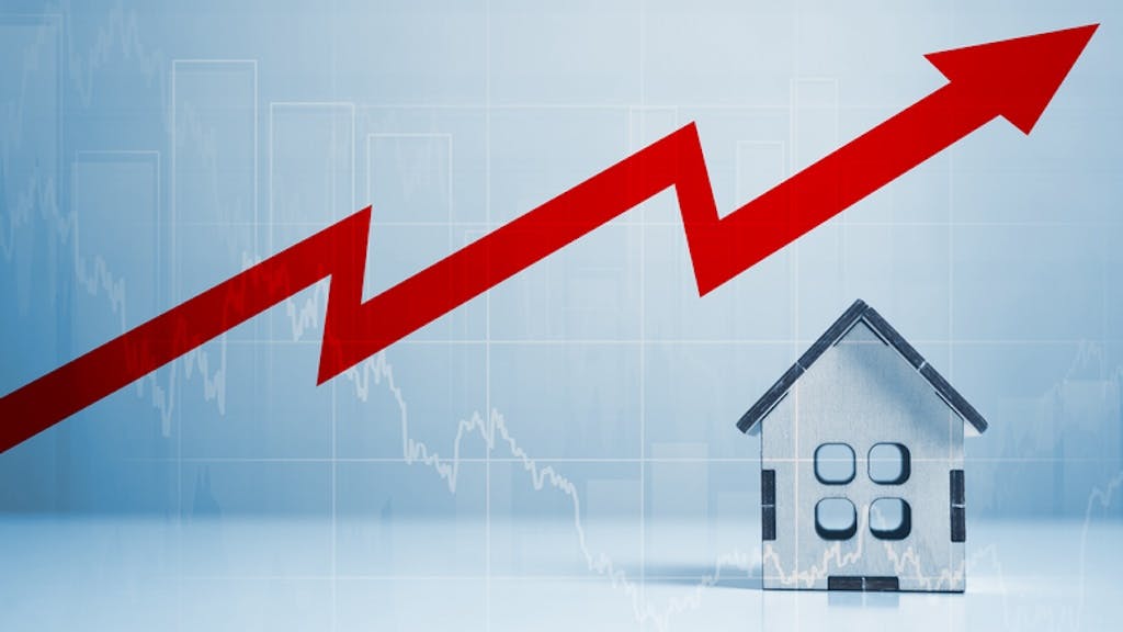 A model home with an arrow above it showing costs increasing