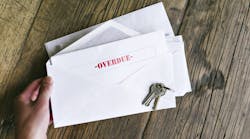 An envelope with an overdue bill notice inside of it An envelope with an overdue bill notice inside of it