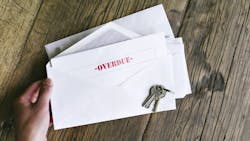 An envelope with an overdue bill notice inside of it An envelope with an overdue bill notice inside of it
