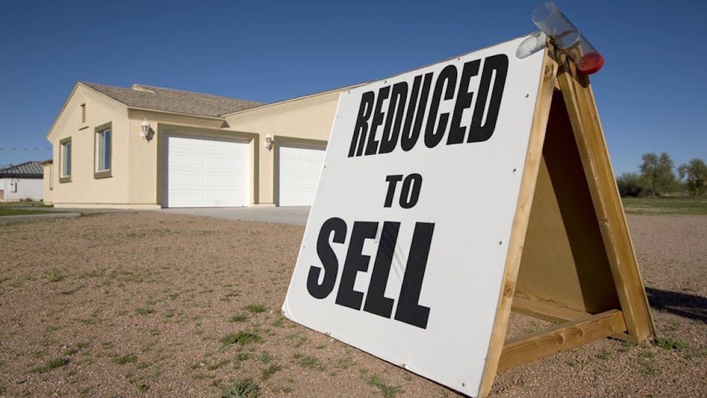 A home with a sign in the front yard that says, 'Reduced to Sell' as the housing market starts to favor buyers