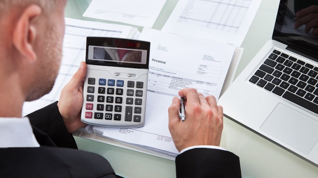 A home builder reviews invoices as part of the value-engineering process.