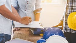 Construction workers working together successfully as a team Construction workers working together successfully as a team