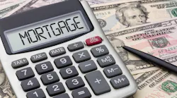 A calculator with the word 'mortgage' on the screen sits on a pile of cash at a time when renting is cheaper than buying a home
