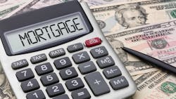 A calculator with the word 'mortgage' on the screen sits on a pile of cash at a time when renting is cheaper than buying a home A calculator with the word 'mortgage' on the screen sits on a pile of cash at a time when renting is cheaper than buying a home