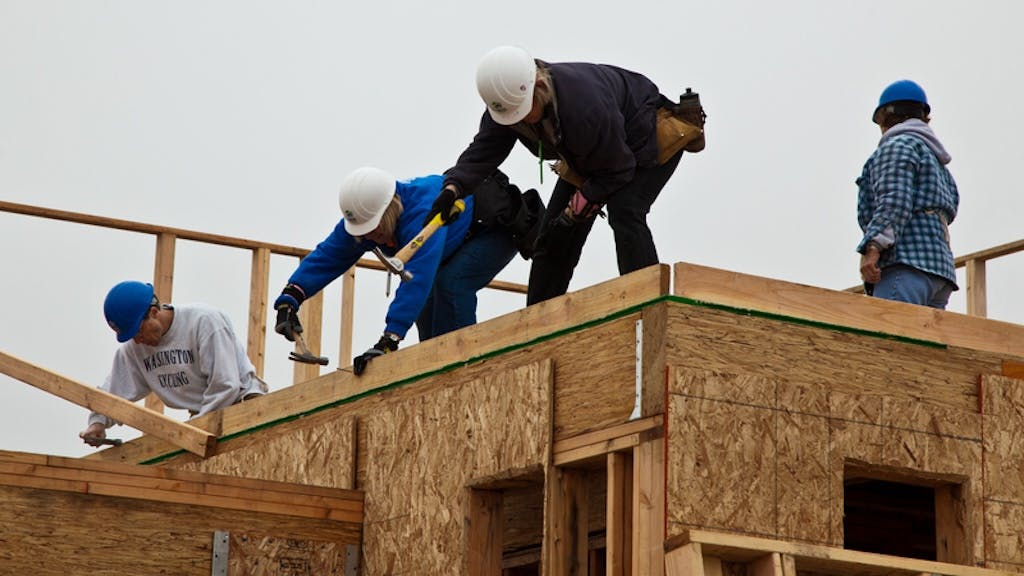 Construction workers on the roof of a home