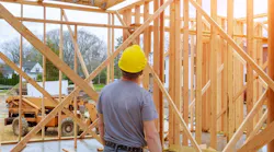 Home builder looks over work at a construction site