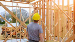 Home builder looks over work at a construction site