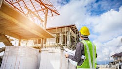 Home builder looks over plans at a jobsite as wage growth for residential professionals slows. Home builder looks over plans at a jobsite as wage growth for residential professionals slows.