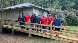 Mungo Homes staff and Home Works workers stands outside a home in Columbia, S.C. Mungo Homes staff and Home Works workers stands outside a home in Columbia, S.C.