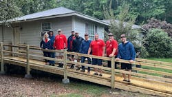 Mungo Homes staff and Home Works workers stands outside a home in Columbia, S.C. Mungo Homes staff and Home Works workers stands outside a home in Columbia, S.C.