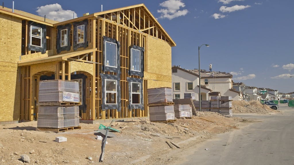 A new home under construction as the price gap between new and existing homes shrinks