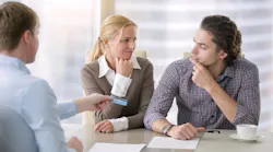Young couple realizes it is a bad time to buy a home while speaking to a real estate agent