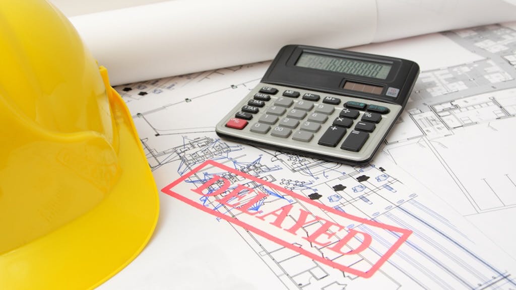 Project plans with a red stamp reading 'Delayed' as the Trump administration's tariffs take effect