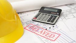 Project plans with a red stamp reading 'Delayed' as the Trump administration's tariffs take effect Project plans with a red stamp reading 'Delayed' as the Trump administration's tariffs take effect