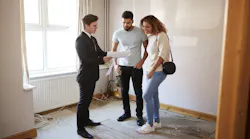 Homebuyers looking at a home with a real estate agent