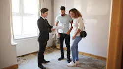 Homebuyers looking at a home with a real estate agent Homebuyers looking at a home with a real estate agent