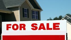 A home with a 'For Sale' sign in the front yard A home with a 'For Sale' sign in the front yard