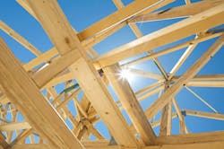 Abstract image of a home under construction, with the sky and sun peeking through Abstract image of a home under construction, with the sky and sun peeking through