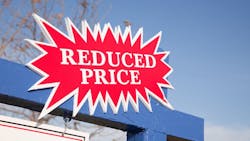 A 'Reduced Price' sign, indicating that a seller has cut the price on their home A 'Reduced Price' sign, indicating that a seller has cut the price on their home