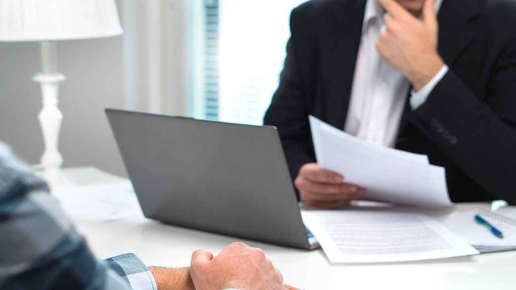 Mortgage broker looking over a mortgage application